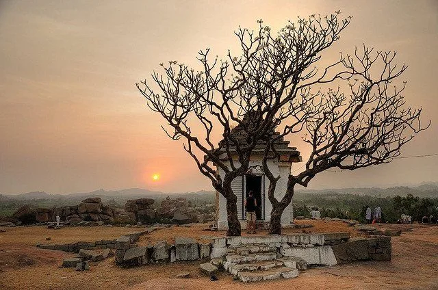 Ancient ruins of Vijayanagara empire at Hampi with boulder landscape at sunset