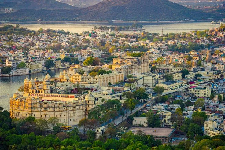 Lake Pichola at dusk with City Palace reflecting on the water in Udaipur